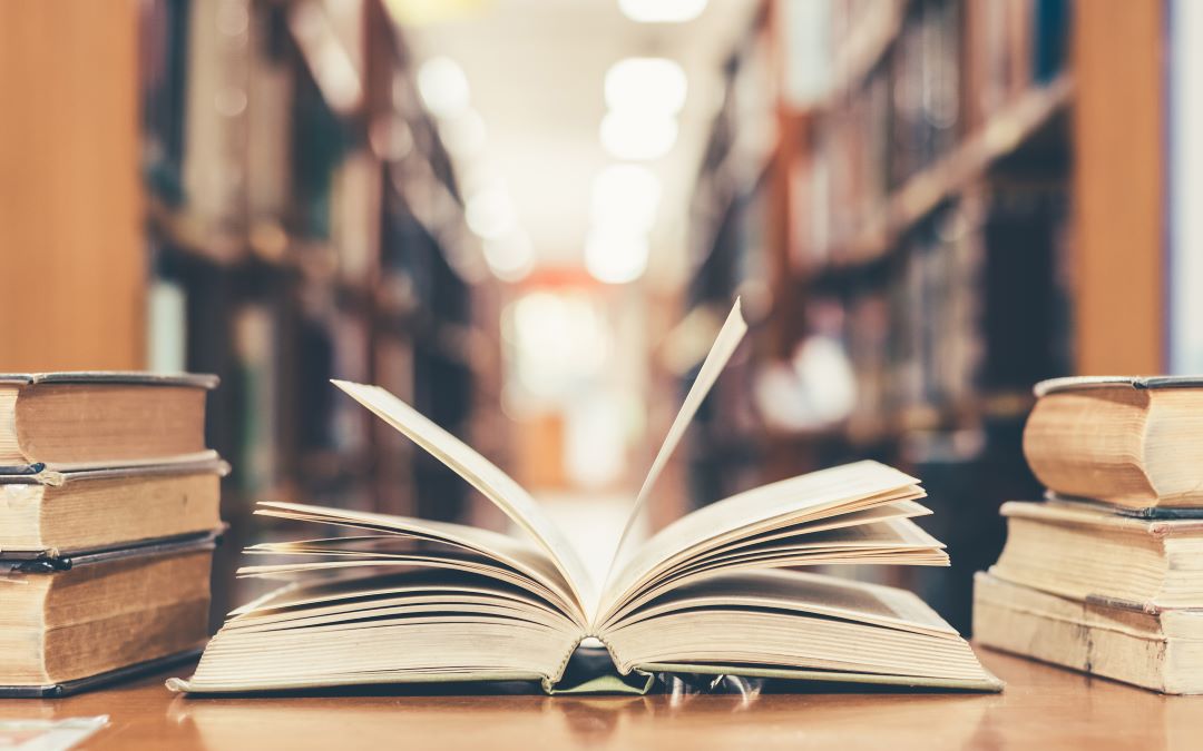 Open book on table in library