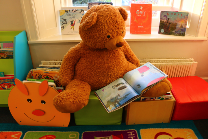 Dundrum's resident teddy bear 'Ted' reading a picture book